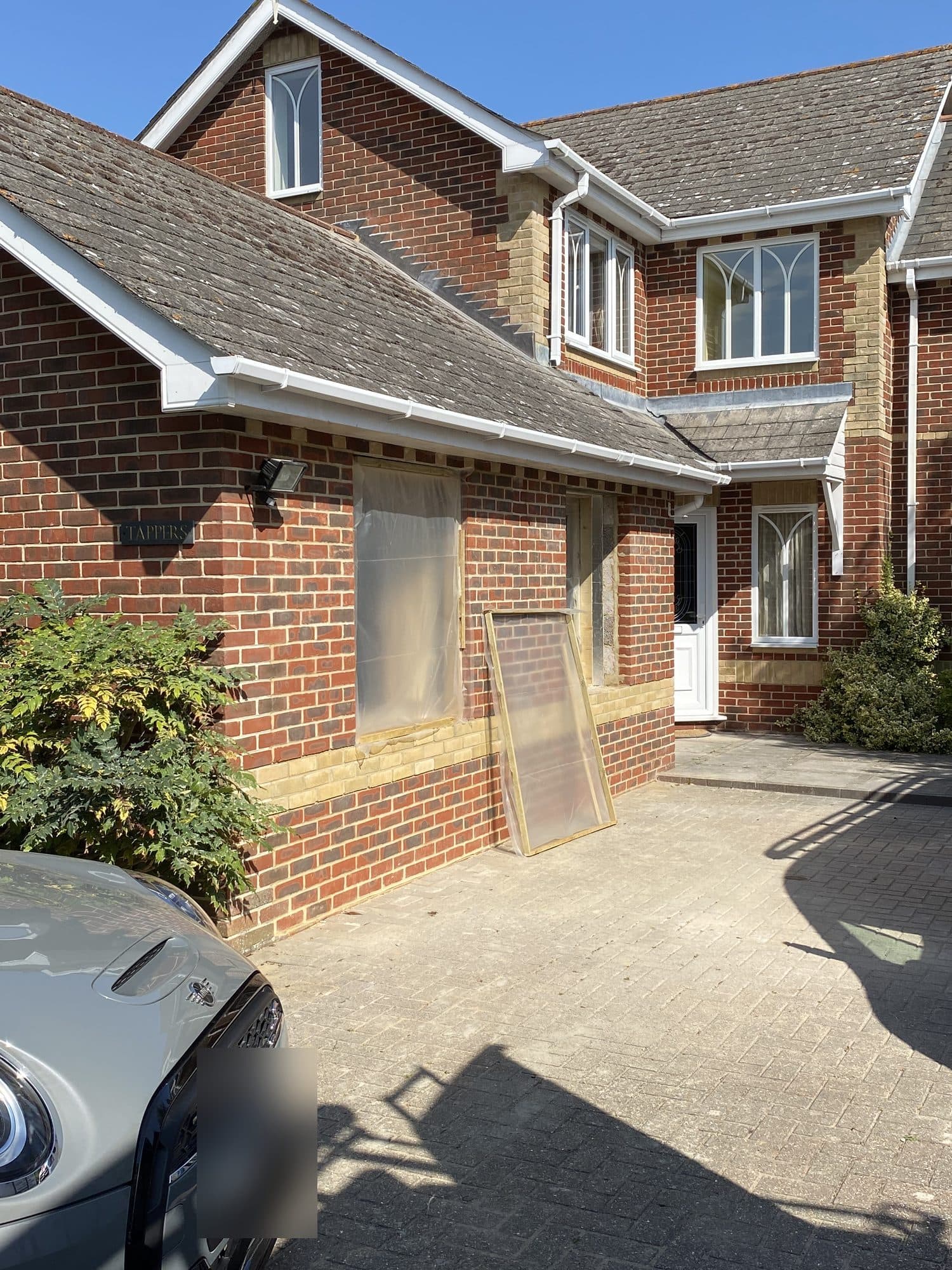 After: garage door bricked up and new windows going in